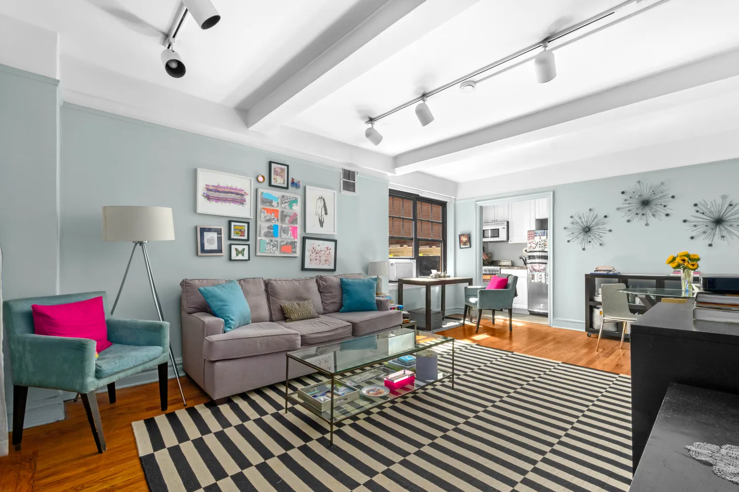 a living room with furniture and wooden floor