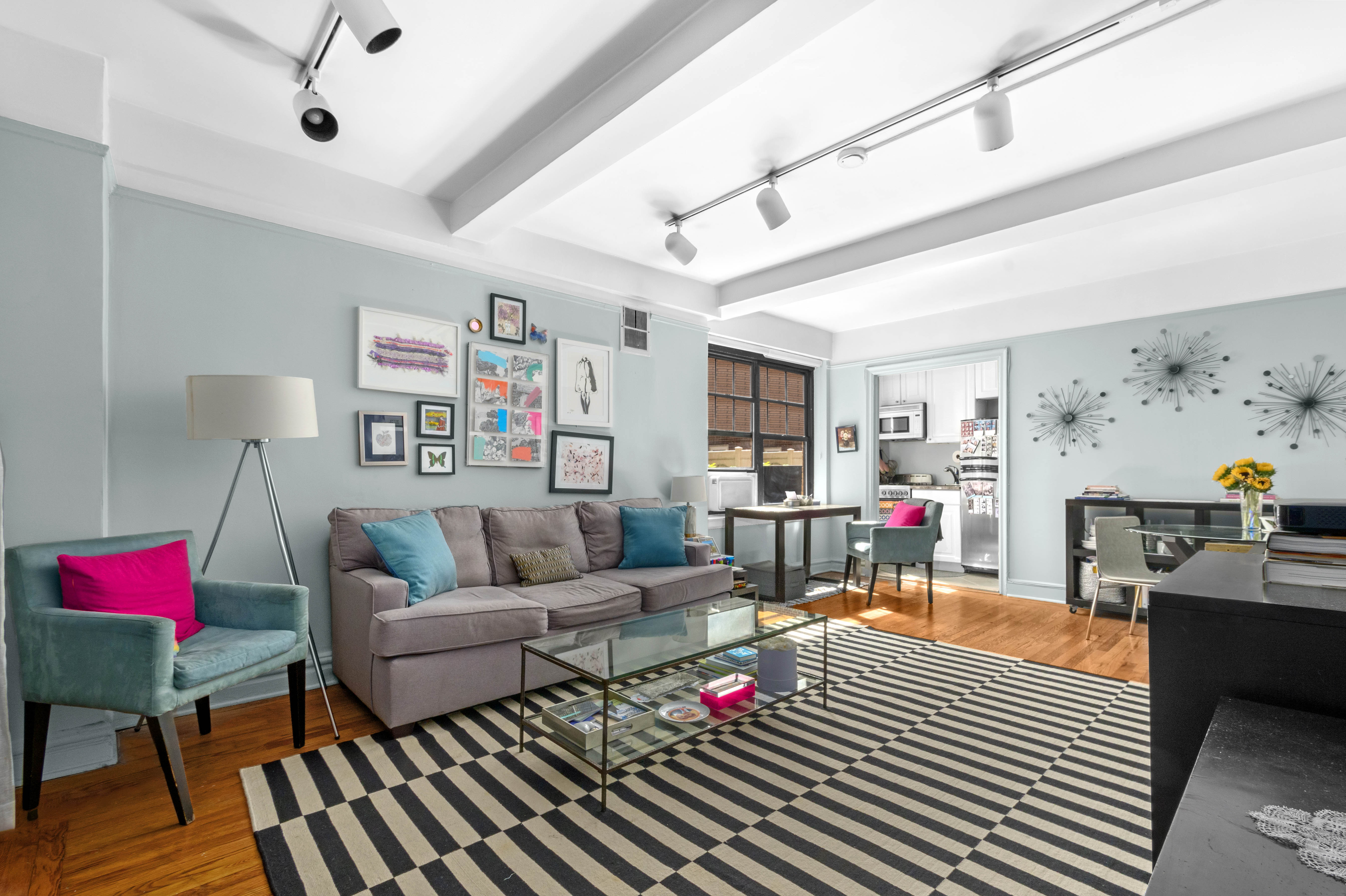 200 East 16th Street, Unit 2M Manhattan, NY 10003 - Photo 1 of 11 a living room with furniture and wooden floor