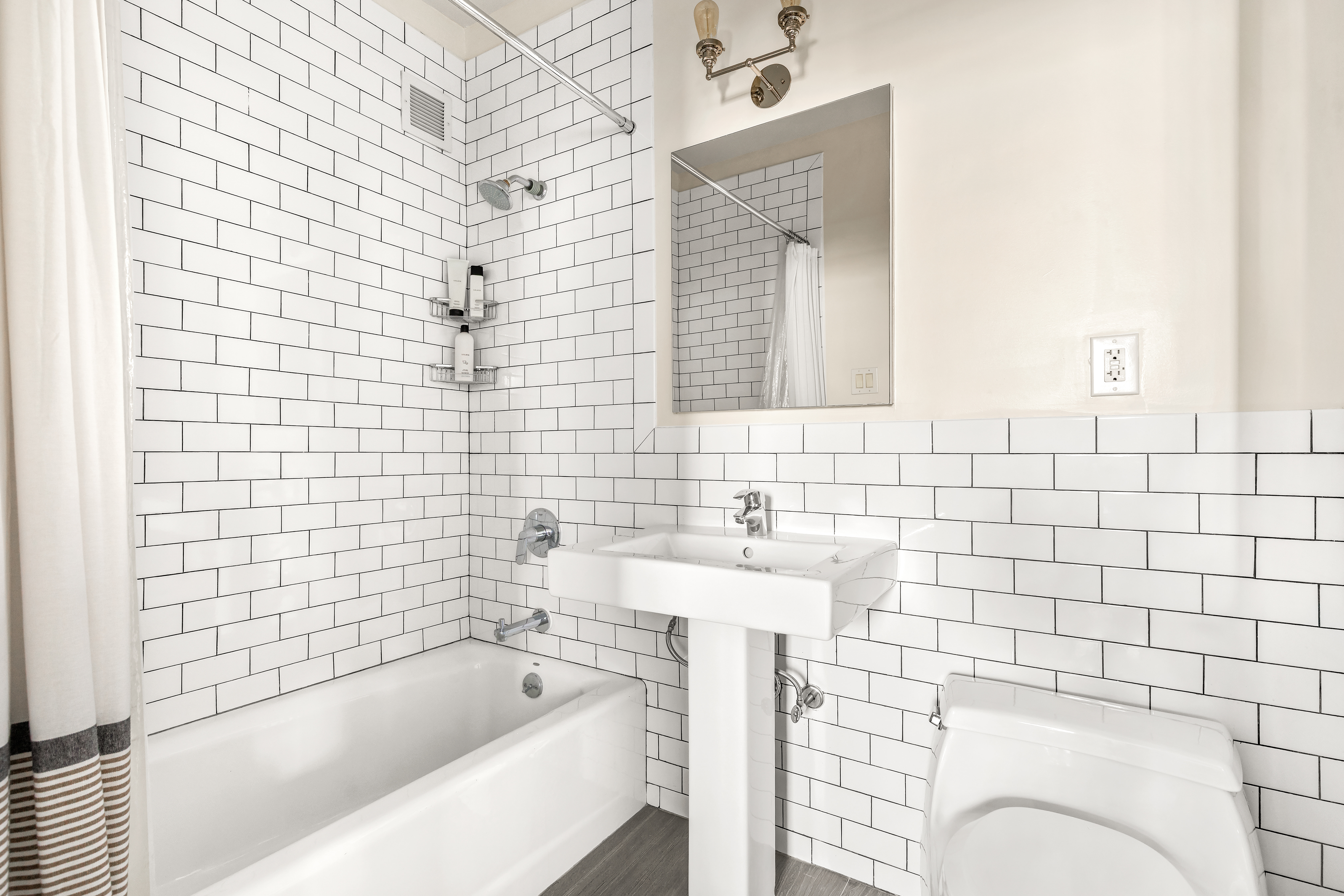 264 Water Street, Unit 6C Manhattan, NY 10038 - Photo 8 of 9 a bathroom with a bathtub and sink