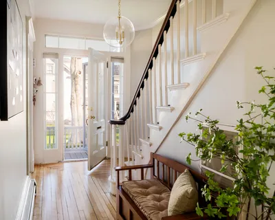 a view of an entryway wooden floor and chandelier