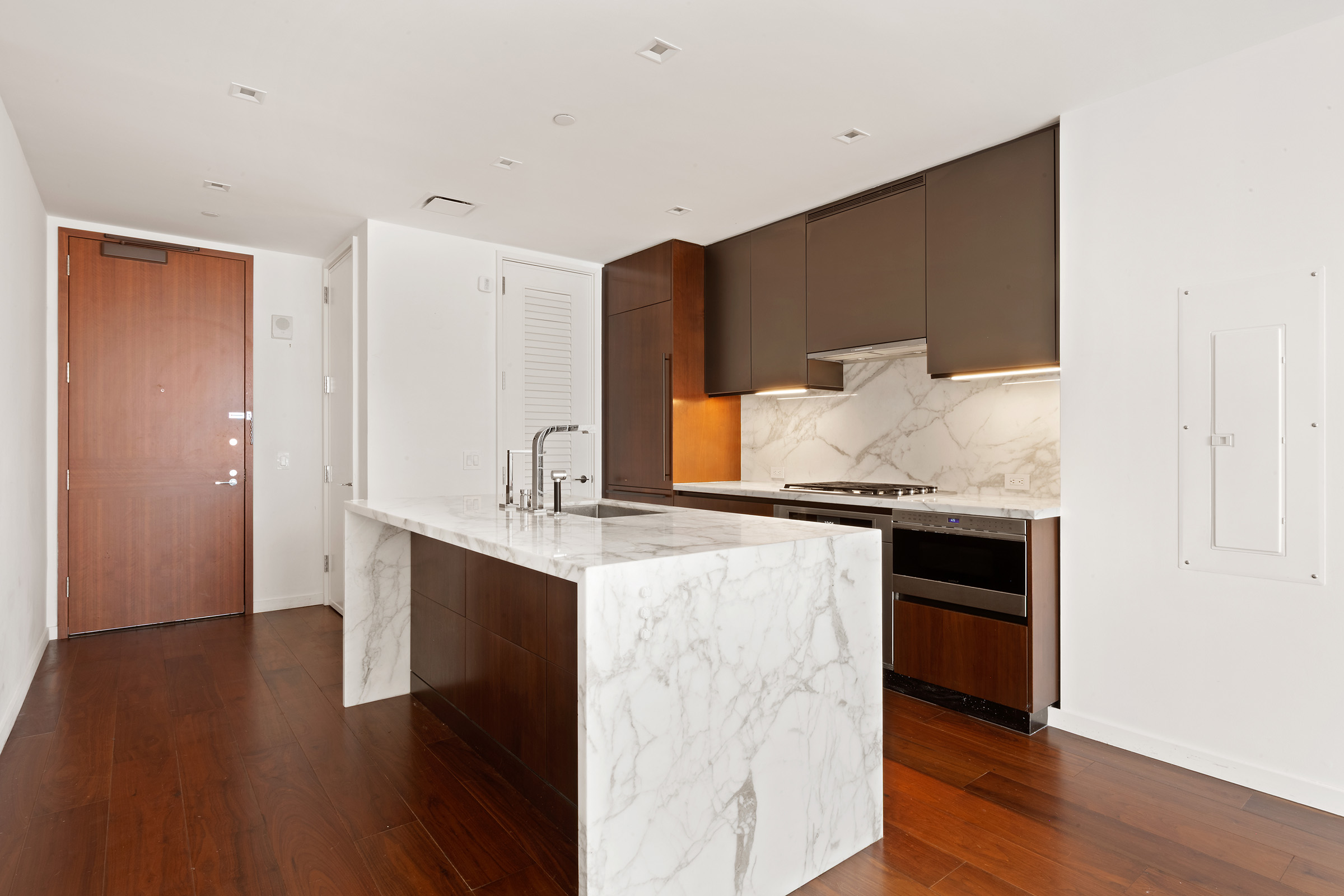 1 West End Avenue, Unit 14G Manhattan, NY 10023 - Photo 2 of 27 a kitchen with granite countertop a sink and cabinets
