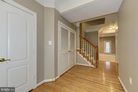 a view of a hallway with wooden floor and staircase