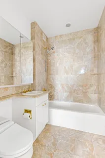 a bathroom with a sink a toilet and bathtub