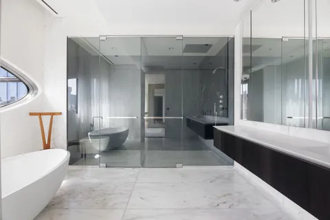 a bathroom with a double vanity sink toilet mirror and bathtub