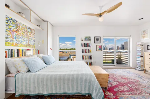 a bedroom with a large bed and a large window