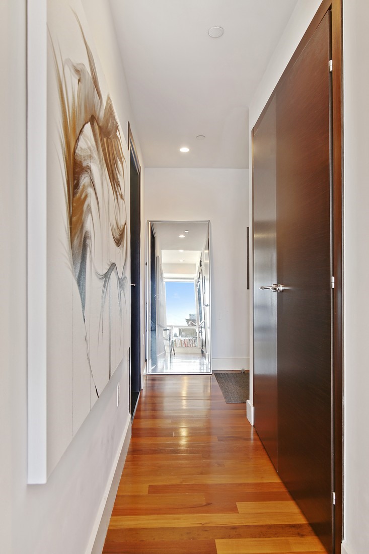 150 Myrtle Avenue, Unit 806 Brooklyn, NY 11201 - Photo 7 of 22 a view of a hallway with wooden floor and a bathroom