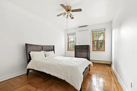 a bedroom with a bed and a chandelier