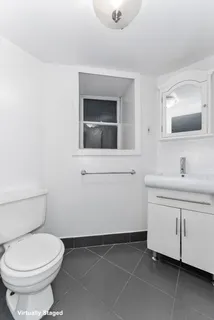 a bathroom with a toilet sink and mirror