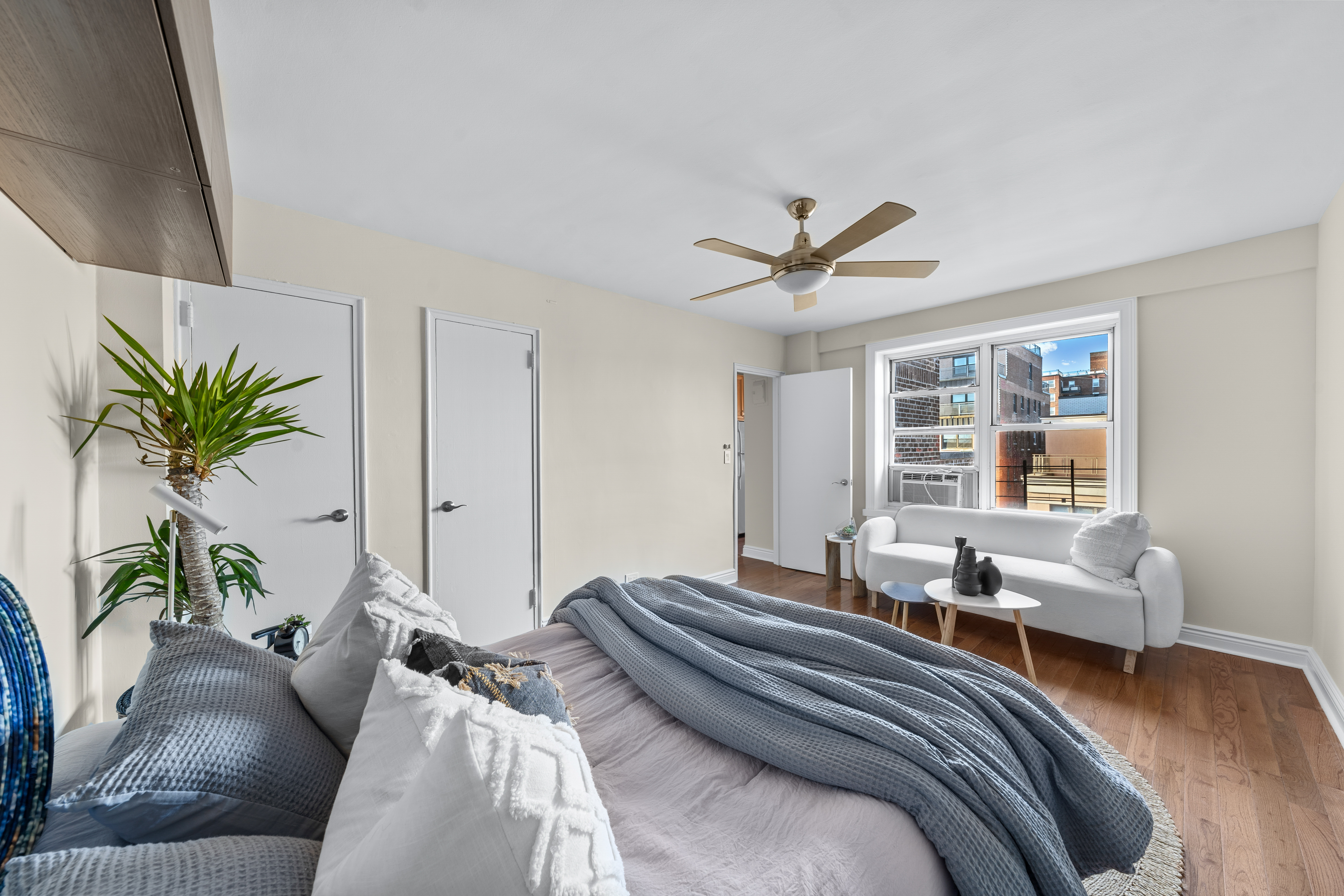 71-36 110th Street, Unit PH7E Queens, NY 11375 - Photo 11 of 16 a bed room with a bed and a couch