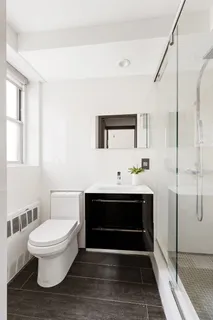 a bathroom with a toilet a sink and mirror