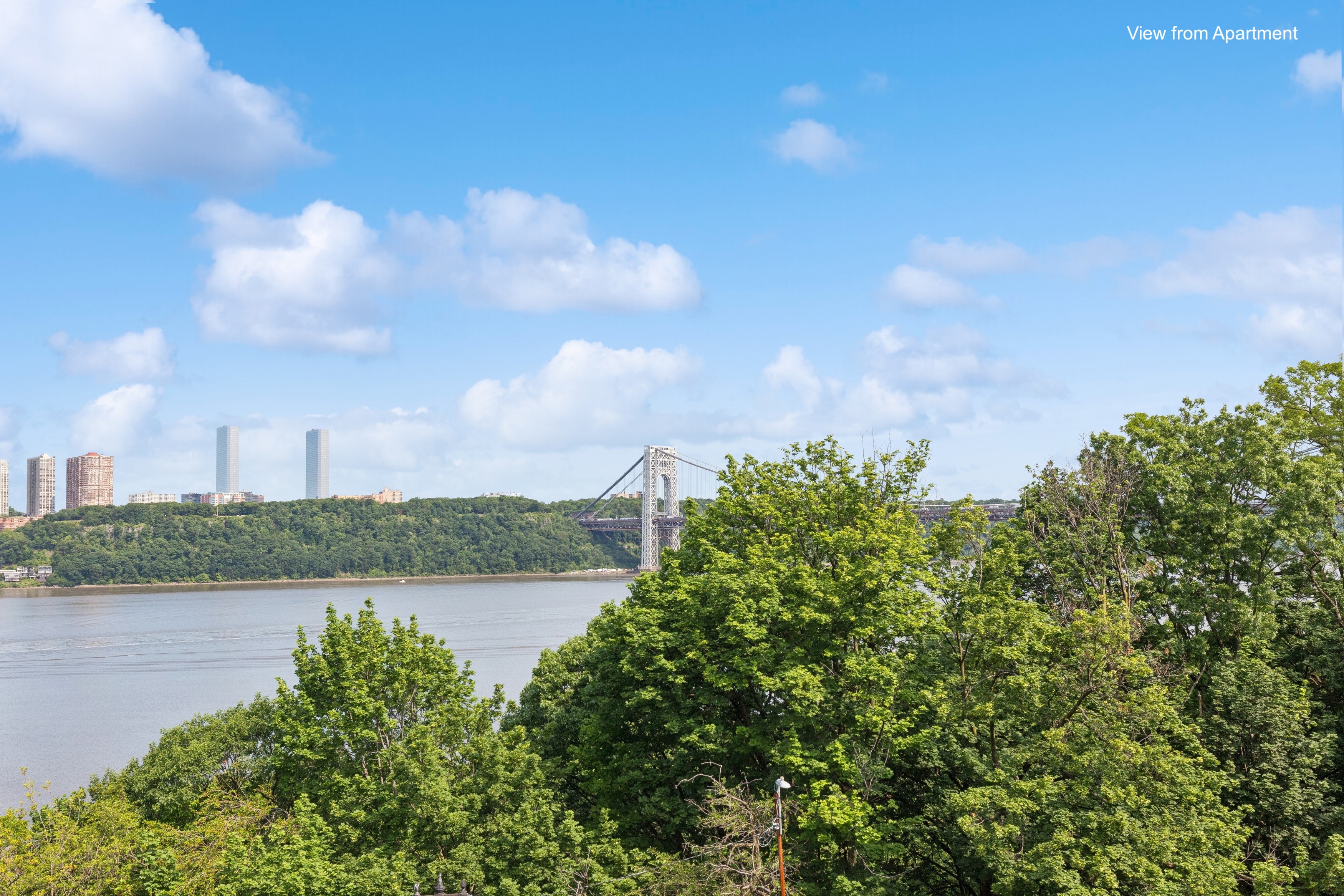 159-34 Riverside Drive West, Unit 5A Manhattan, NY 10032 - Photo 13 of 29 a view of a lake with houses in the back