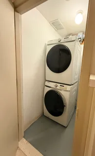 a view of a patio with table and chairs potted plants and a barbeque