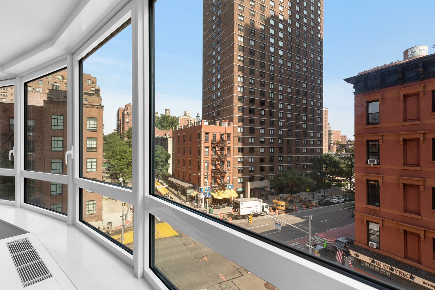 200 East 94th Street, Unit 315 Manhattan, NY 10128 - Photo 6 of 25 a view of a balcony with a floor to ceiling window next to a tall building