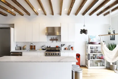 a kitchen with furniture a flat screen tv and potted plant
