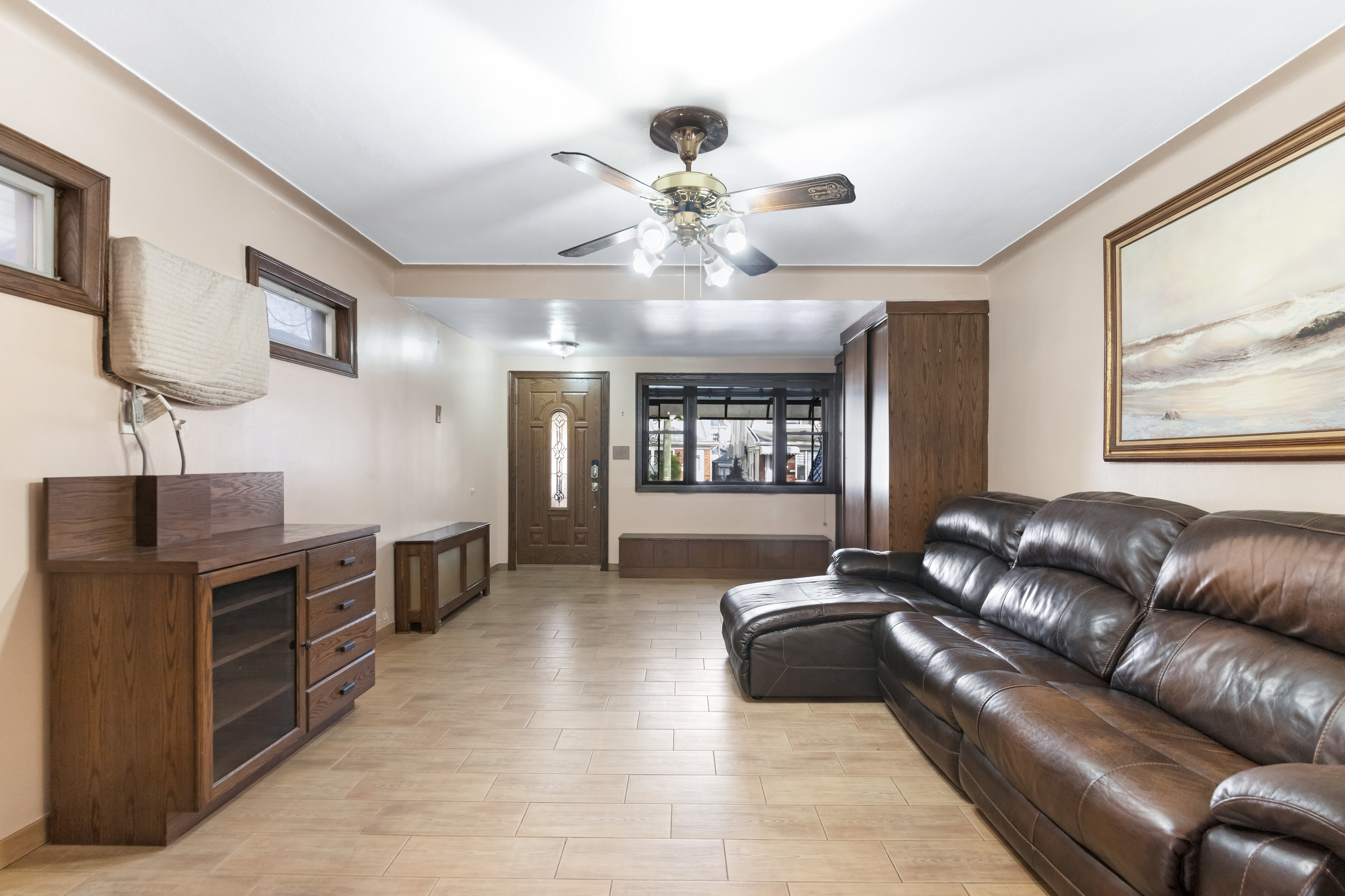 1874 Ryder Street Brooklyn, NY 11234 - Photo 4 of 20 a living room with furniture a chandelier and a flat screen tv
