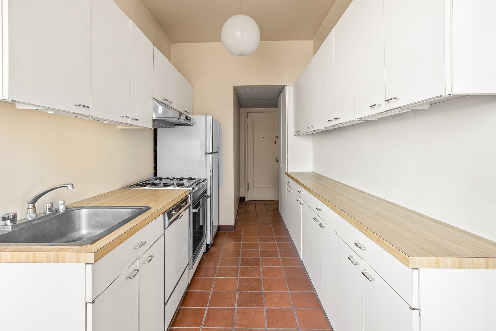 30 Sutton Place, Unit 12E Manhattan, NY 10022 - Photo 5 of 8 a kitchen with granite countertop a sink and cabinets