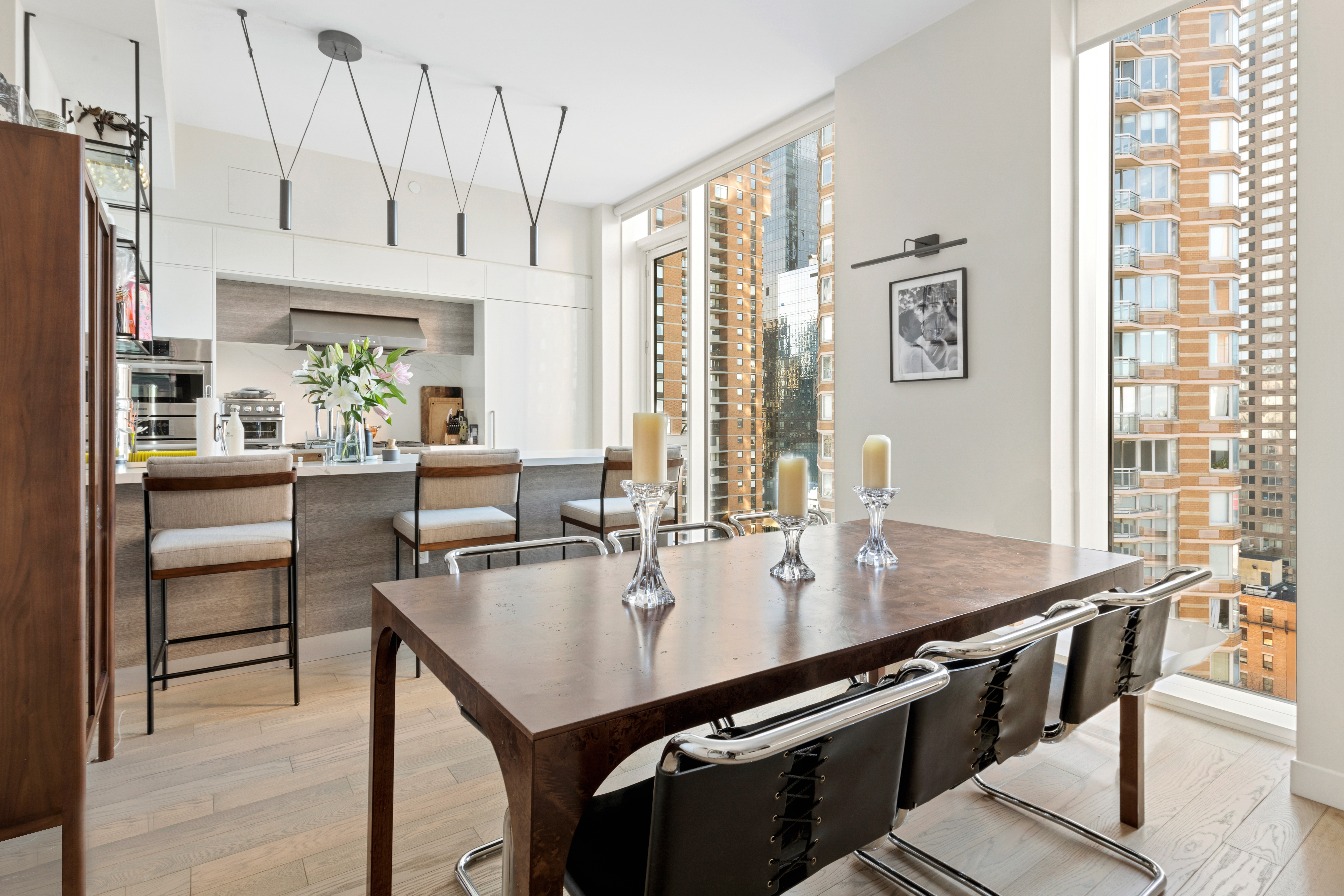 505-513 West 43rd Street, Unit PHG Manhattan, NY 10036 - Photo 4 of 20 a kitchen with stainless steel appliances granite countertop a sink a stove and a refrigerator