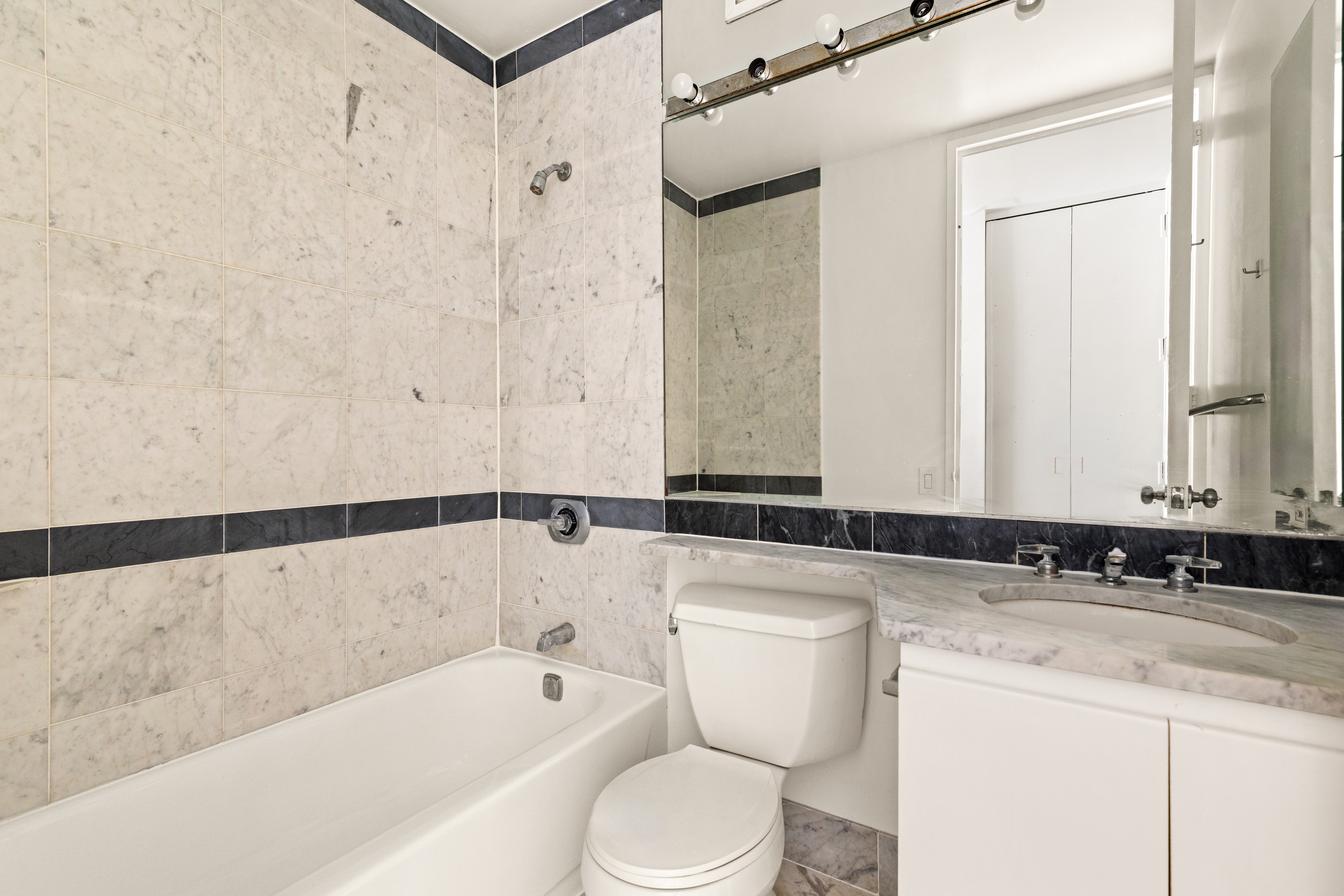 500 West 43rd Street, Unit 5C Manhattan, NY 10036 - Photo 5 of 9 a bathroom with a bathtub and a sink