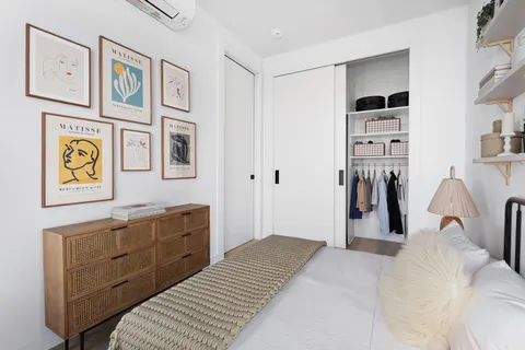 a bedroom with a bed and a chandelier