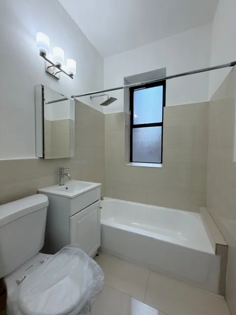 a bathroom with a toilet a sink and bathtub