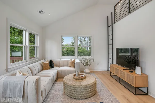 a living room with furniture and a large window