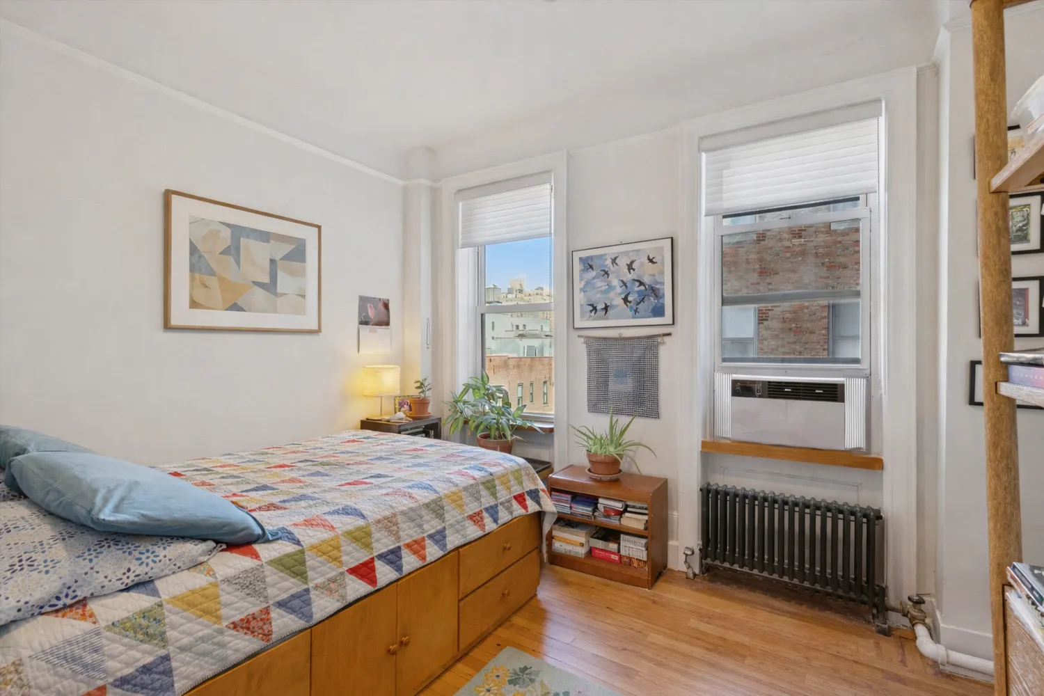 a bedroom with a bed and a window with balcony