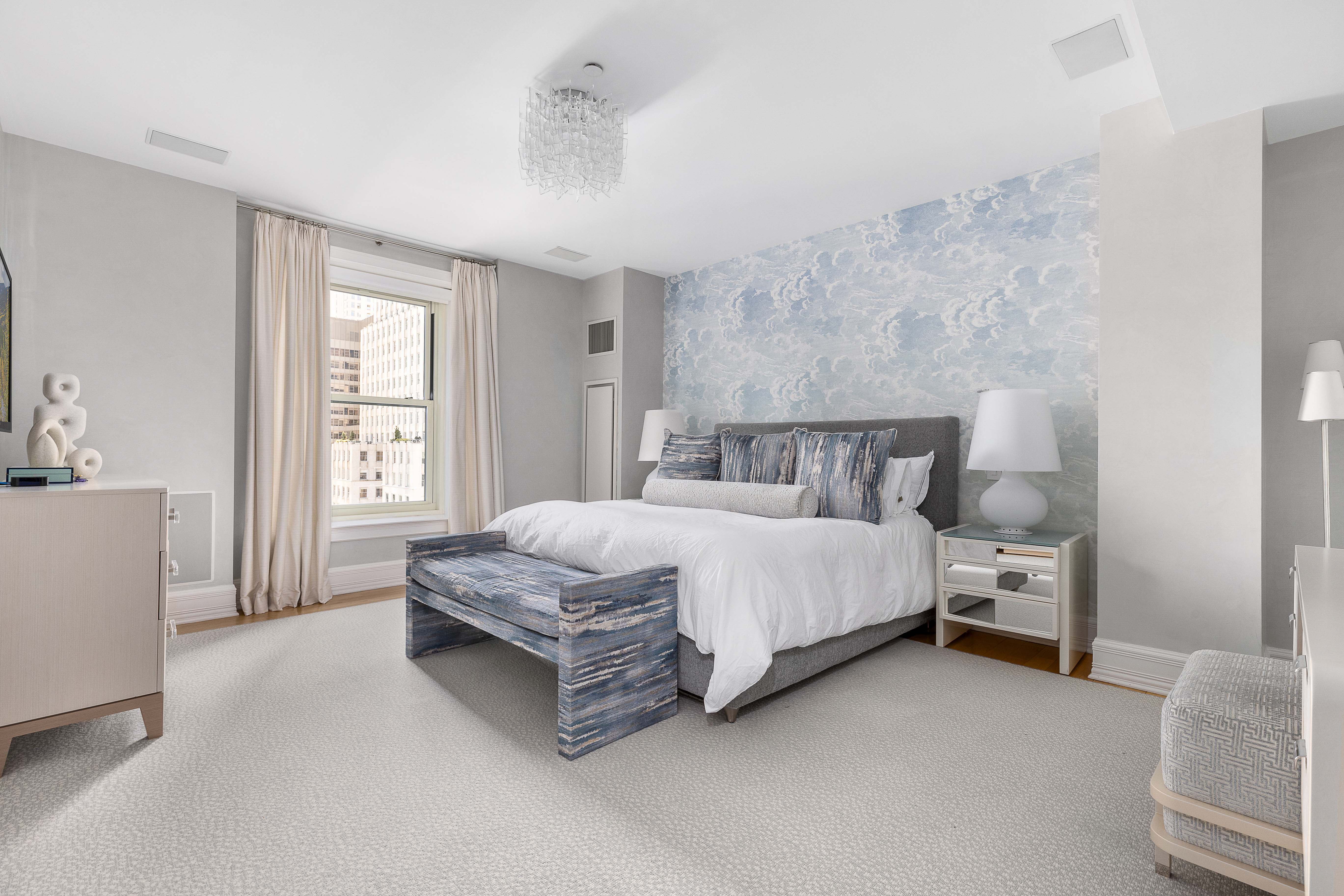 1 Central Park South, Unit 1513 Manhattan, NY 10019 - Photo 9 of 29 a spacious bedroom with a bed and a couch