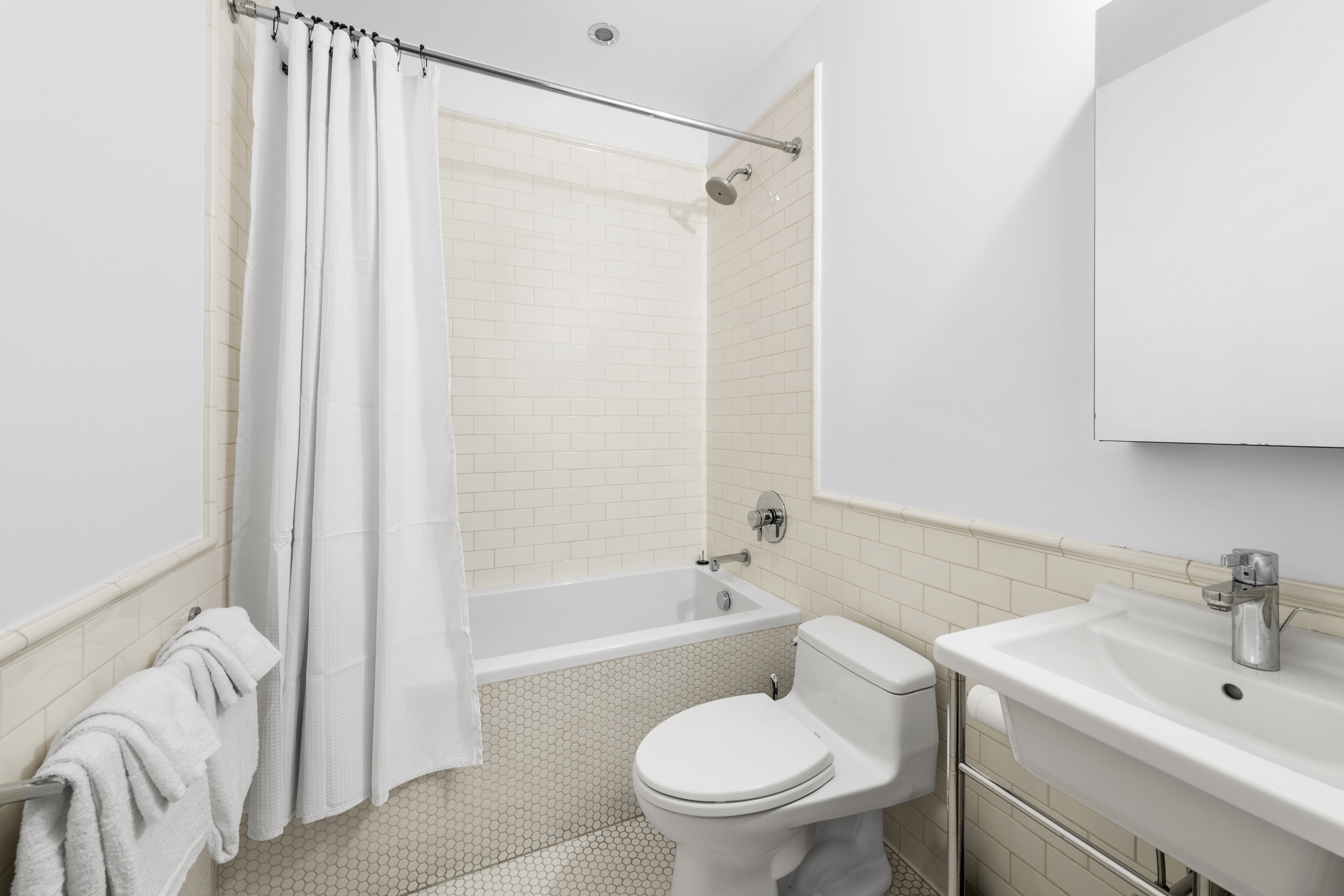 60 Collister Street, Unit 1B Manhattan, NY 10013 - Photo 11 of 20 a bathroom with a sink toilet and shower