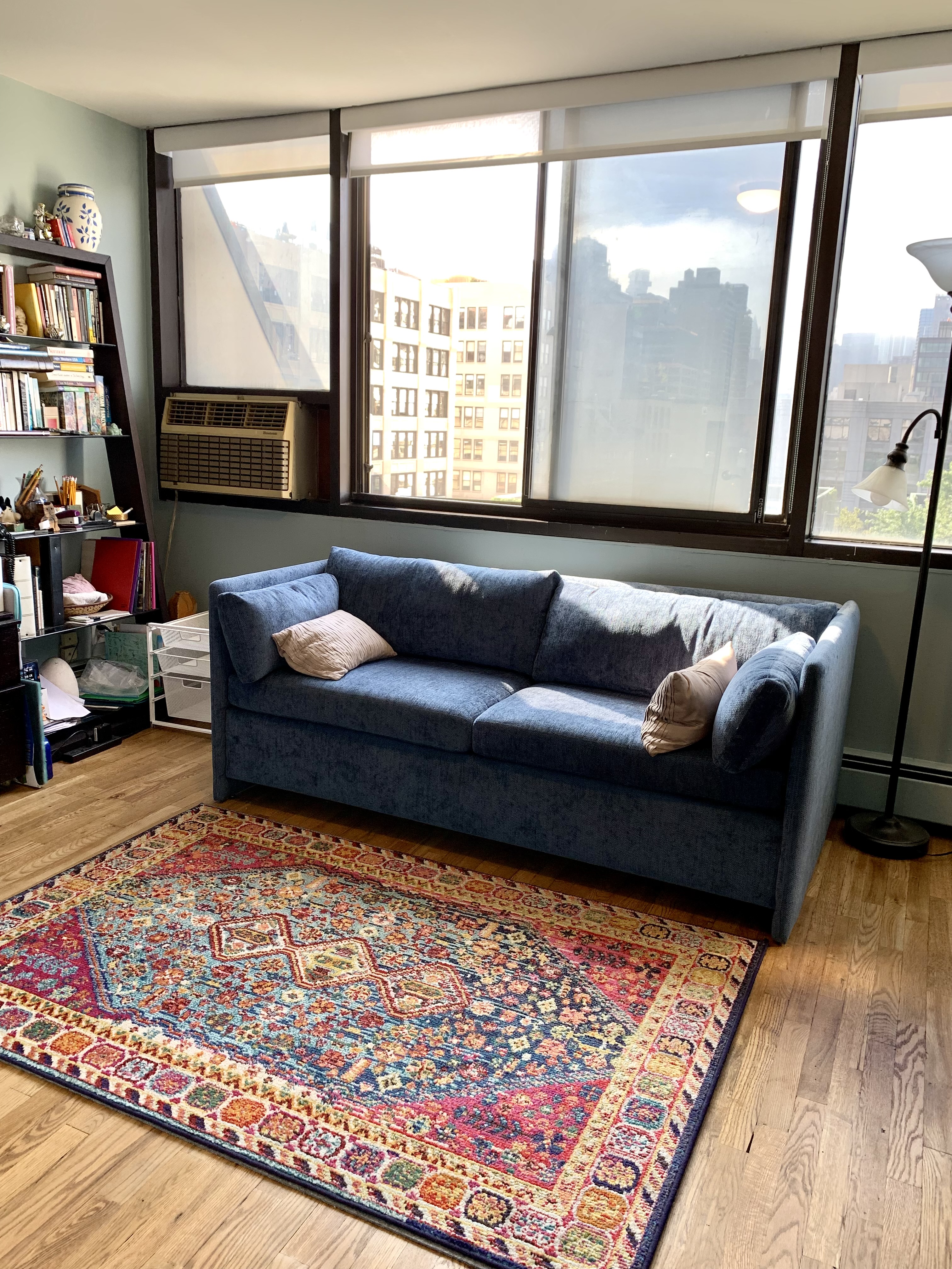130 Barrow Street, Unit PH508 Manhattan, NY 10014 - Photo 5 of 14 a living room with a couch and a floor to ceiling window