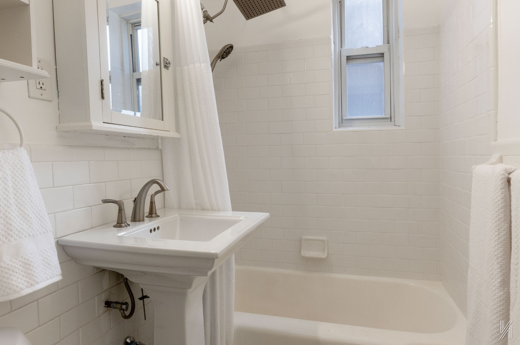 39-55 51st Street, Unit 3G Queens, NY 11377 - Photo 16 of 18 a bathroom with a sink a mirror and a bathtub