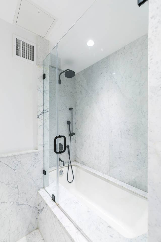 265 East Houston Street, Unit 4 Manhattan, NY 10002 - Photo 14 of 20 a bathroom with a granite countertop shower and a sink