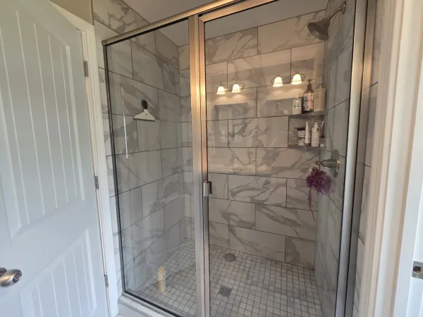 a bathroom with a glass shower door