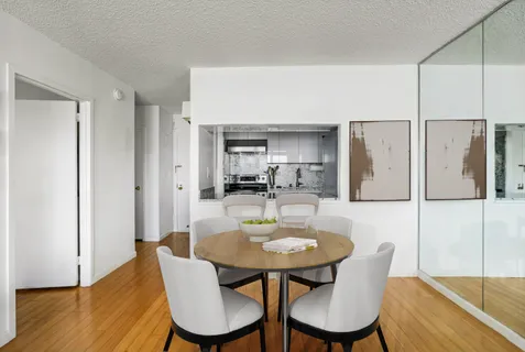 a view of a kitchen with wooden floor and a refrigerator