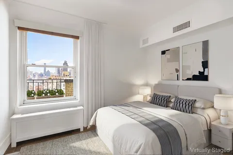 a bedroom with a bed and a window with outer view