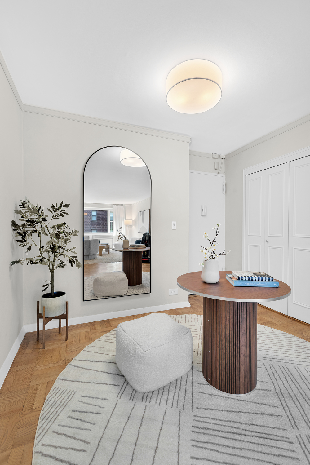 411 East 53rd Street, Unit 8C Manhattan, NY 10022 - Photo 6 of 10 a living room with furniture a table and kitchen view