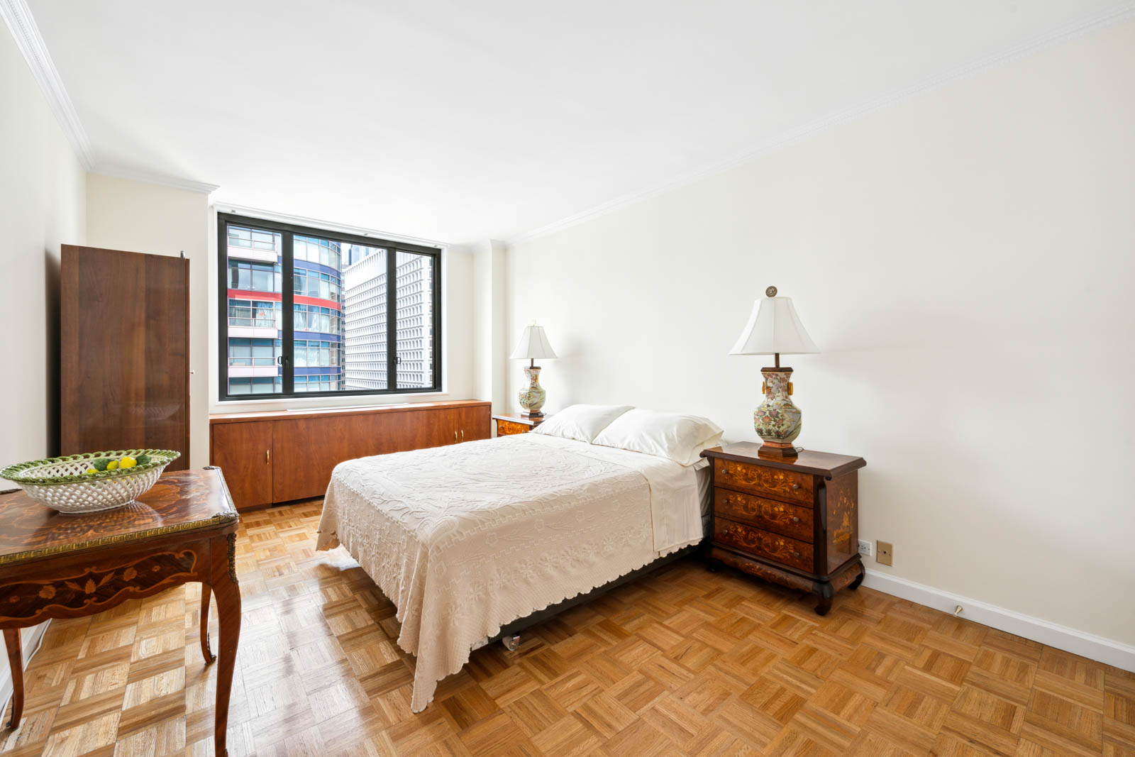 300 East 54th Street, Unit 34GF Manhattan, NY 10022 - Photo 7 of 16 a bedroom with bed and window