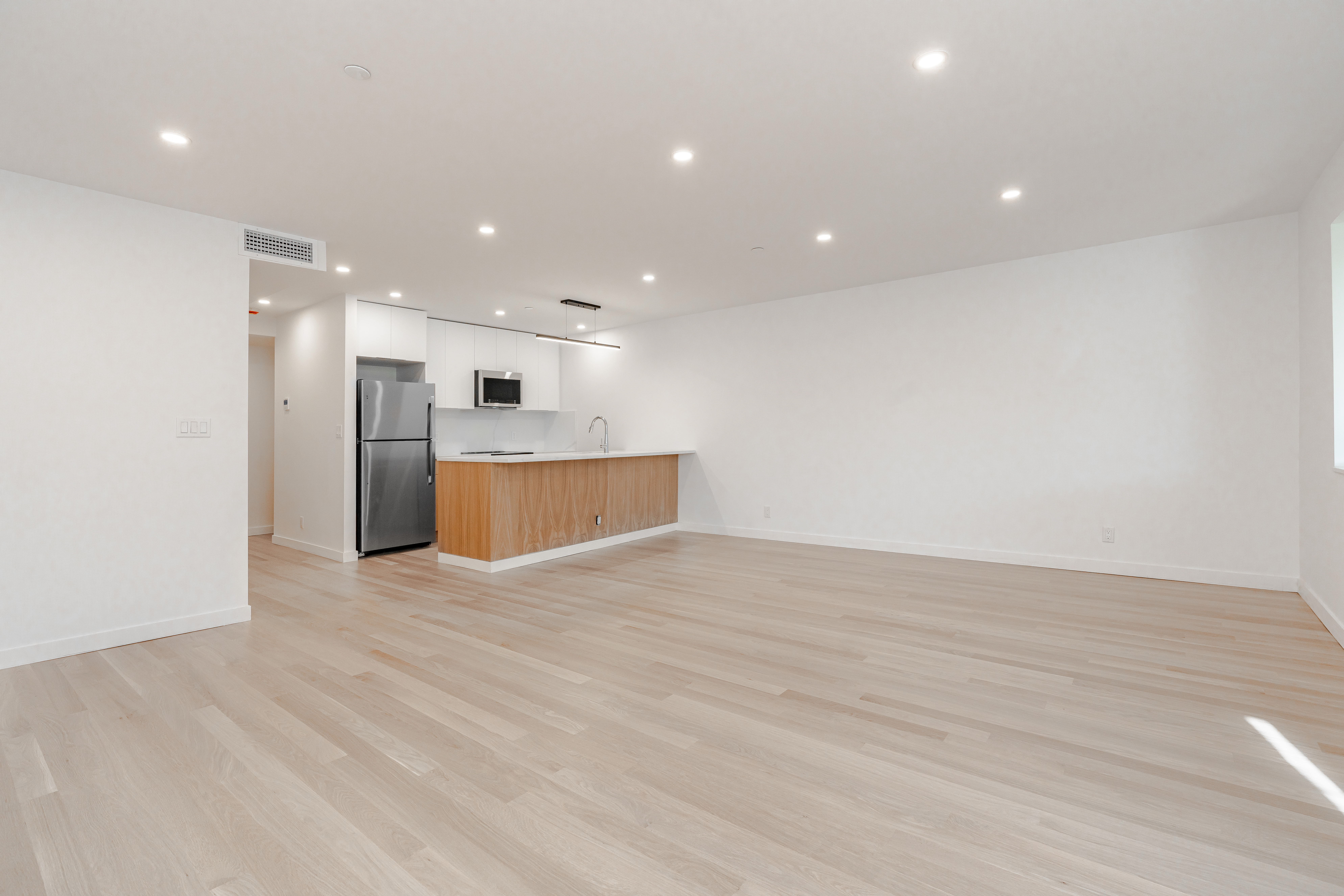 20-15 46th Street, Unit 2 Queens, NY 11105 - Photo 3 of 16 a view of empty room with wooden floor