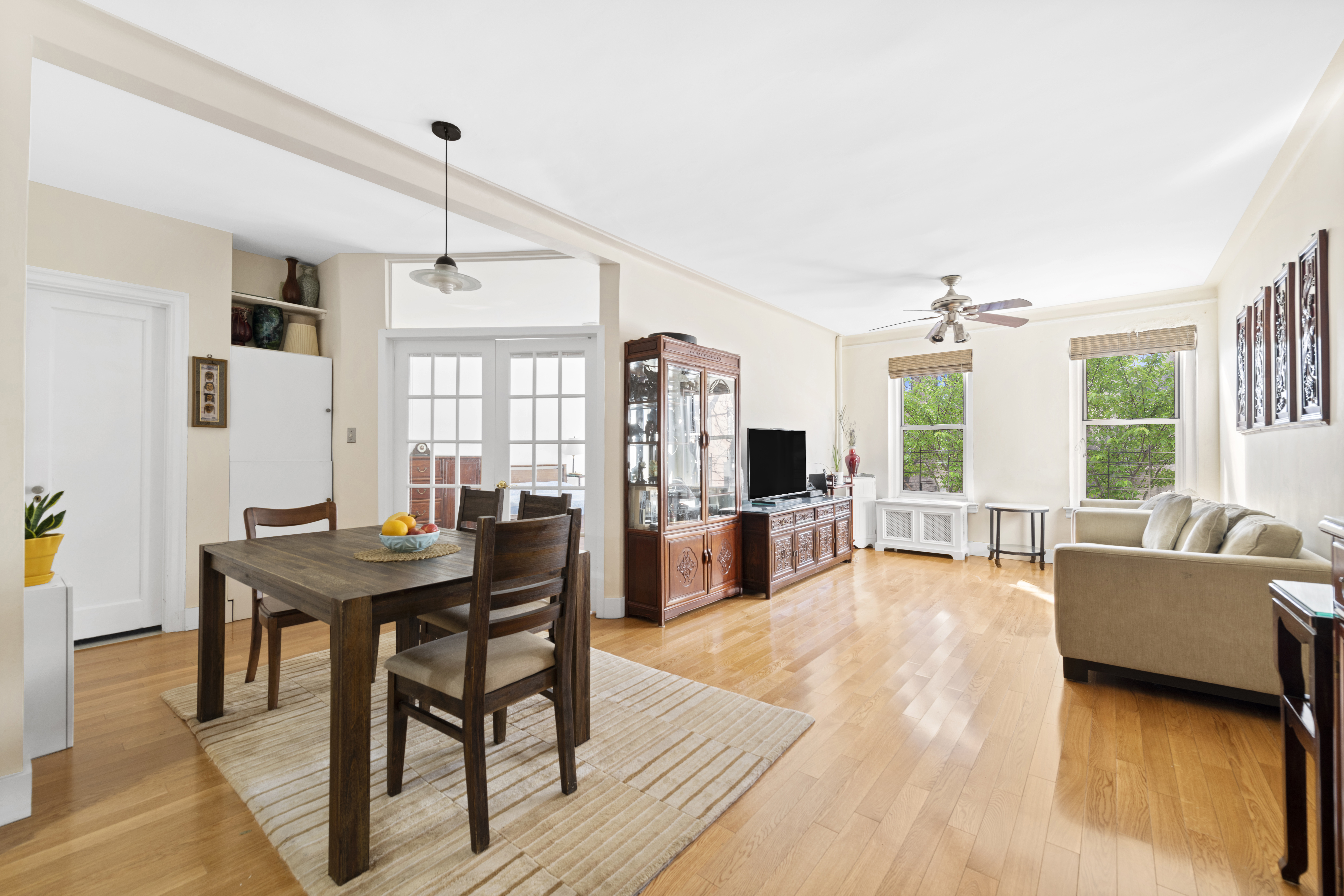 a living room with furniture a table and large windows