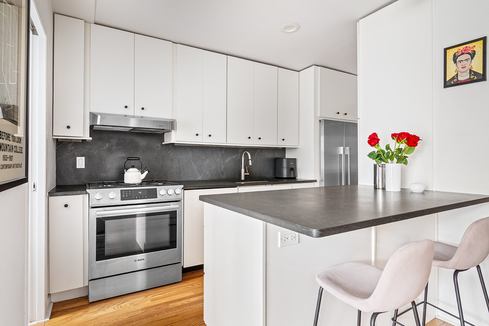 525 Ocean Parkway, Unit 2B Brooklyn, NY 11218 - Photo 3 of 12 a kitchen with granite countertop white cabinets and white appliances