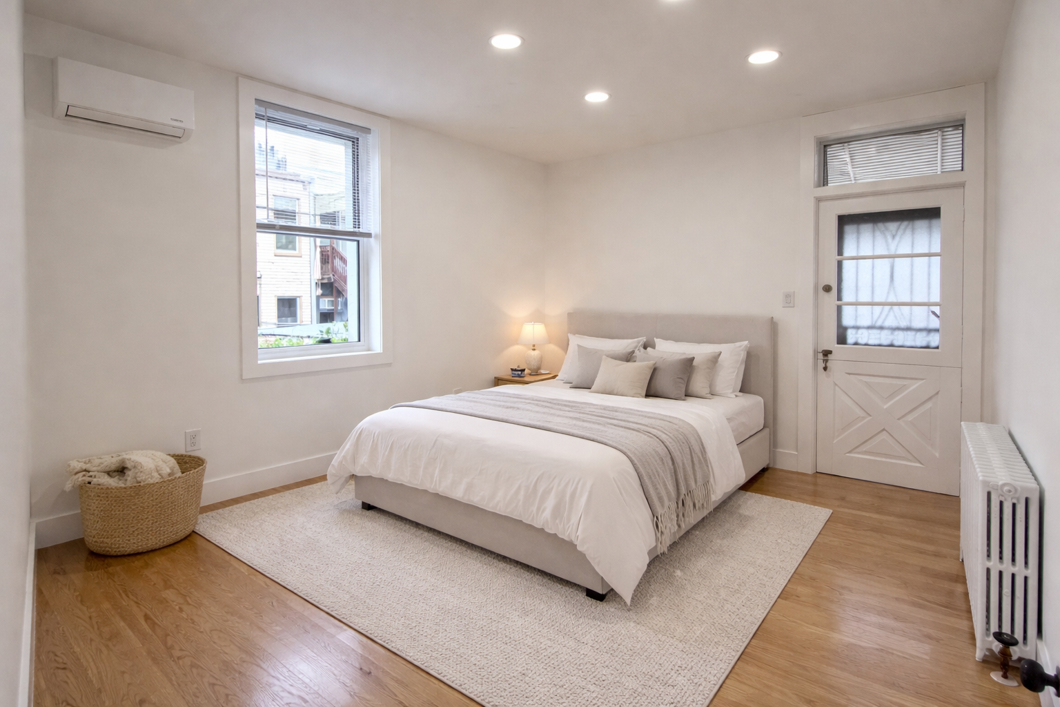 18-61 Dekalb Avenue, Unit 1 Queens, NY 11385 - Photo 4 of 12 a bedroom with a bed and a window