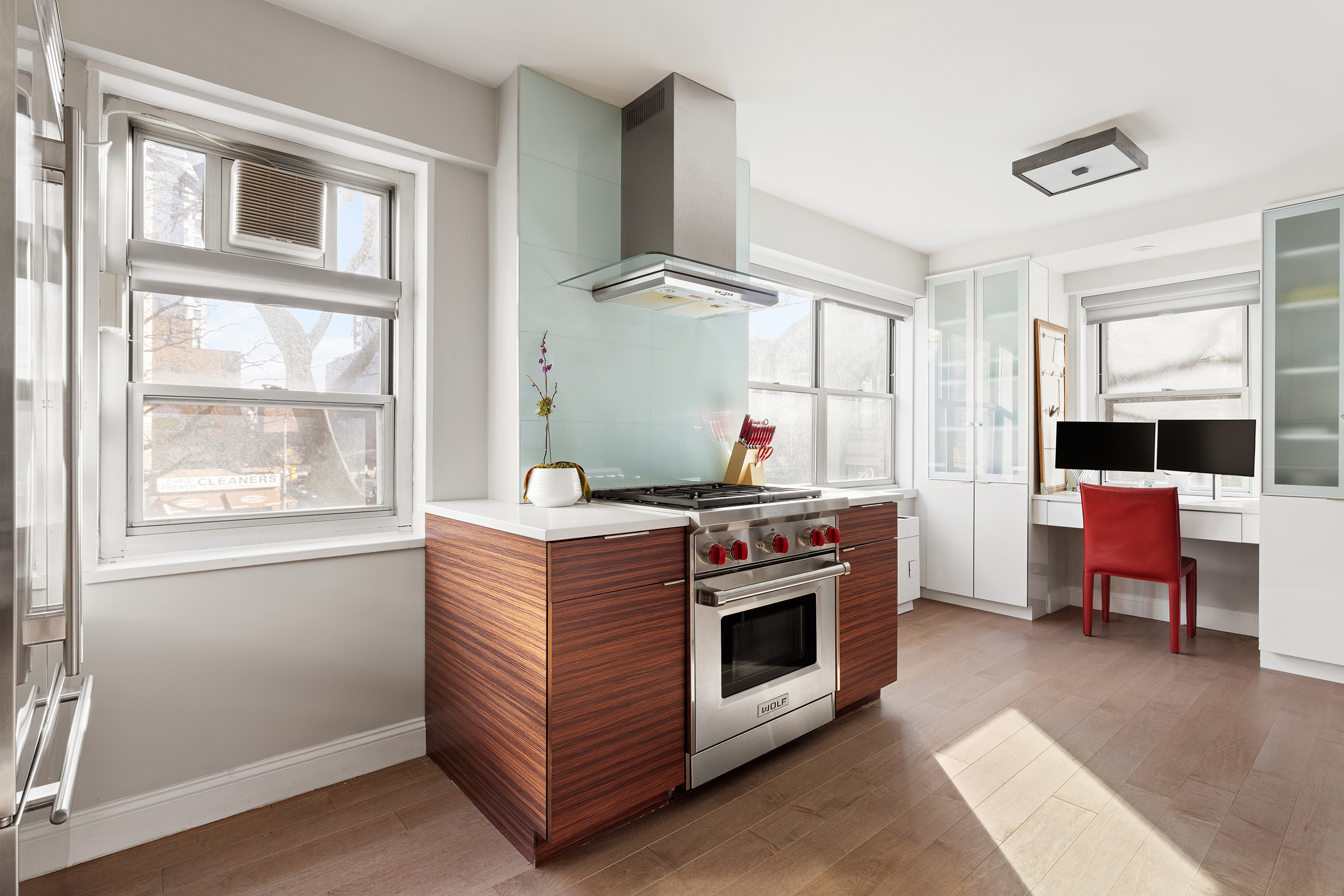 70 East 10th Street, Unit 3B Manhattan, NY 10003 - Photo 4 of 11 a kitchen with stainless steel appliances granite countertop a stove and a refrigerator