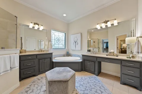 a spacious bathroom with a bathtub sink and a mirror