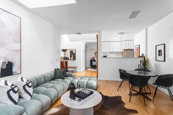 a living room with furniture and kitchen view