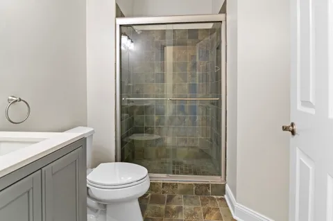 a bathroom with a shower and a toilet