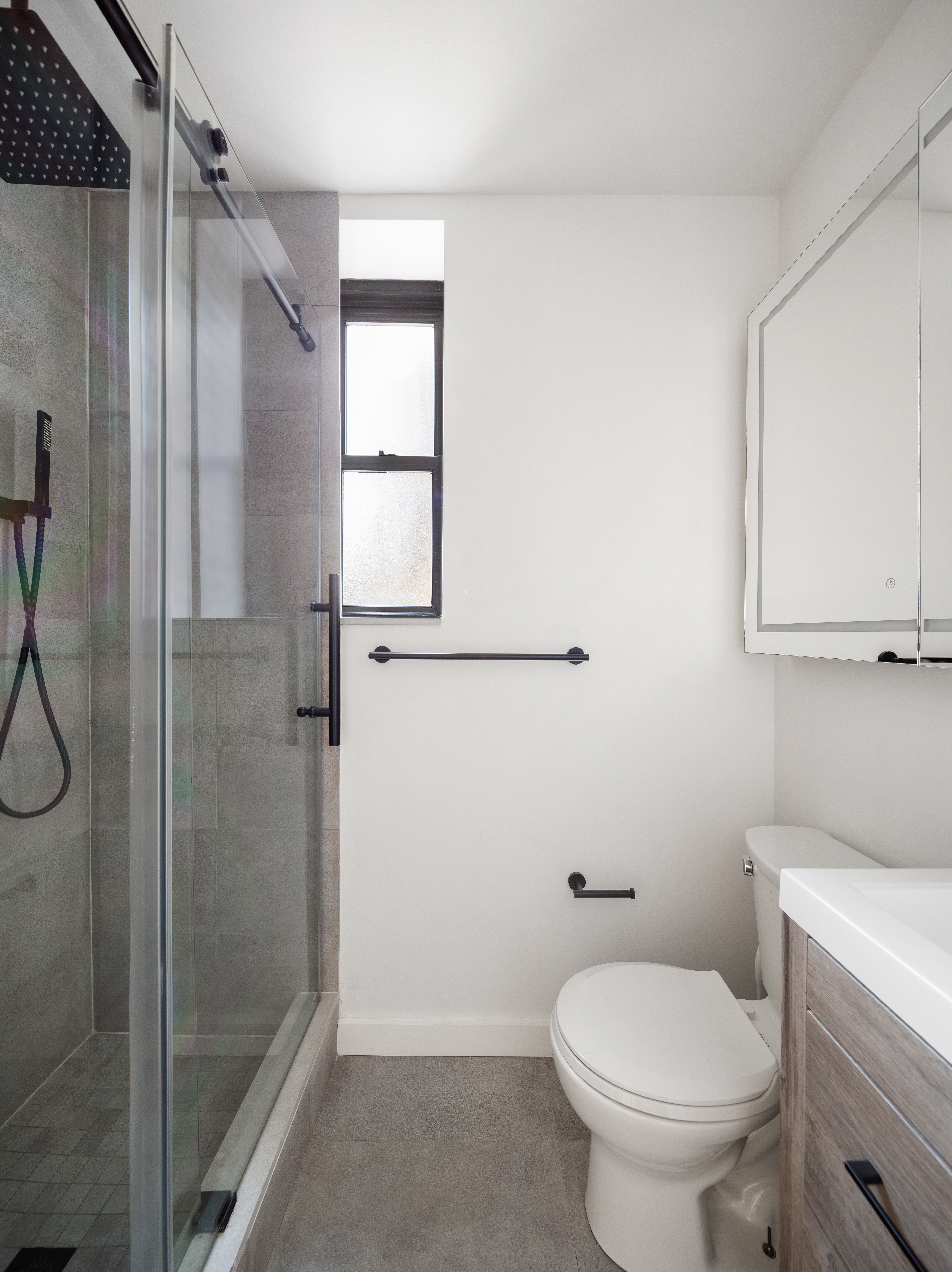 28 Perry Street, Unit 4W Manhattan, NY 10014 - Photo 6 of 7 a bathroom with a toilet and a shower