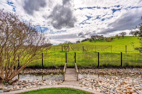 a view of a park with iron fence