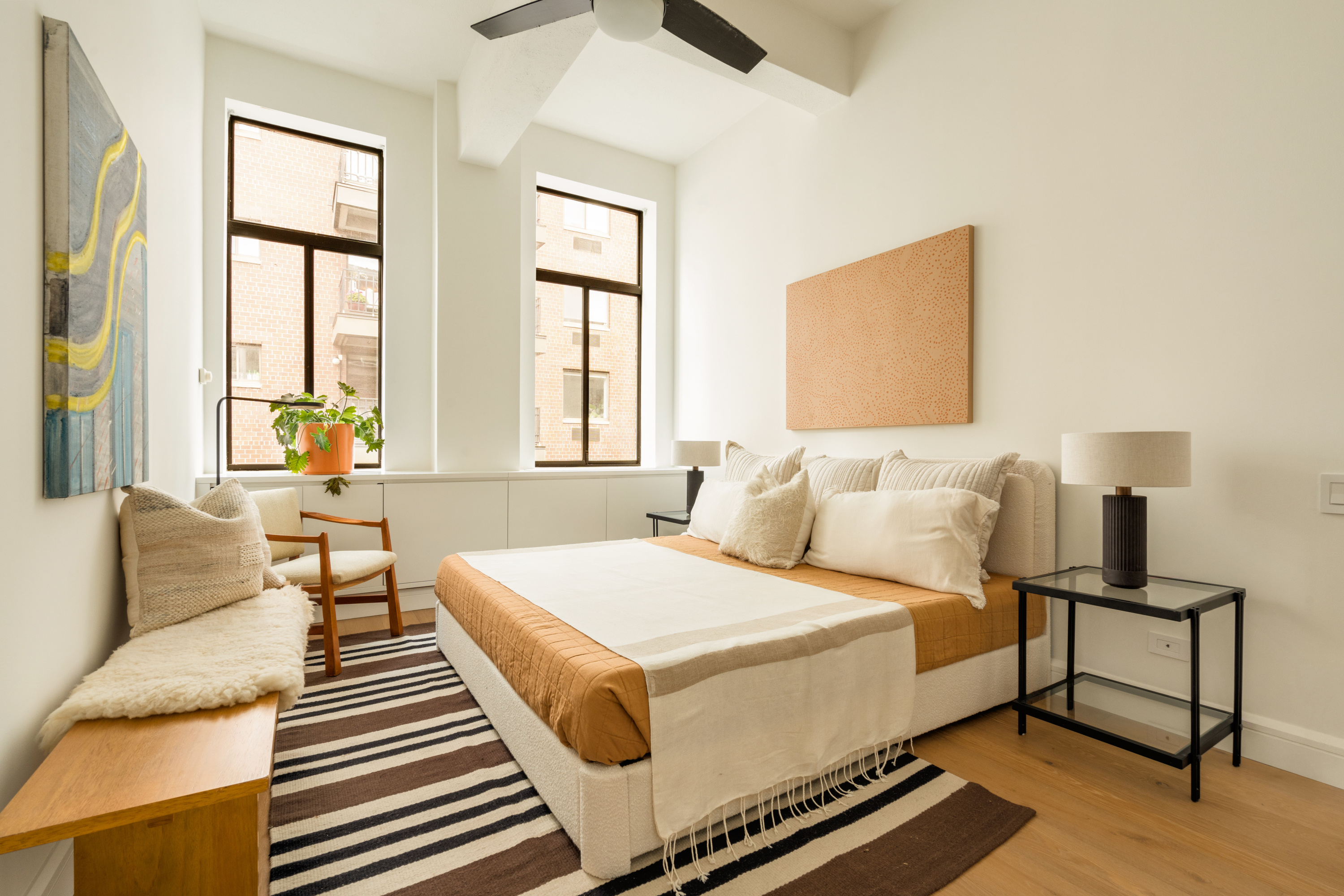 165 Perry Street, Unit 5A Manhattan, NY 10014 - Photo 6 of 14 a bedroom with a bed and wooden floor