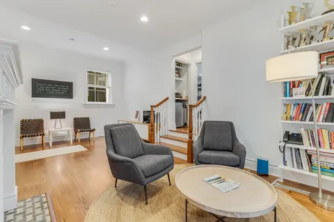 a living room with furniture and a book shelf