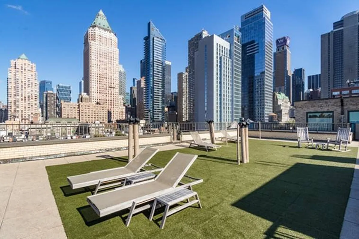 325 West 45th Street, Unit 205 Manhattan, NY 10036 - Photo 9 of 14 a swimming pool with outdoor seating and yard