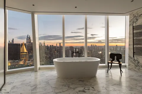 a spacious bathroom with a bathtub and next to a window